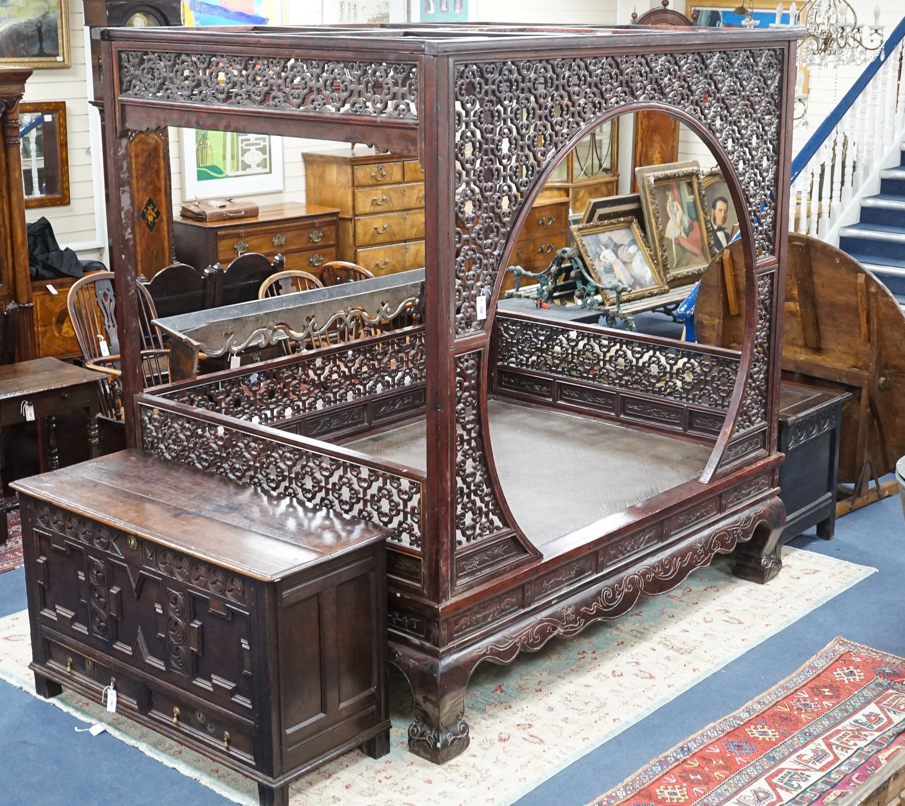 A Chinese carved elm opium bed, width 160cm, depth 207cm, height 225cm